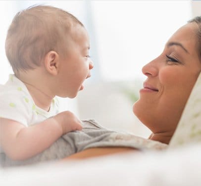 mother cuddles baby on her chest